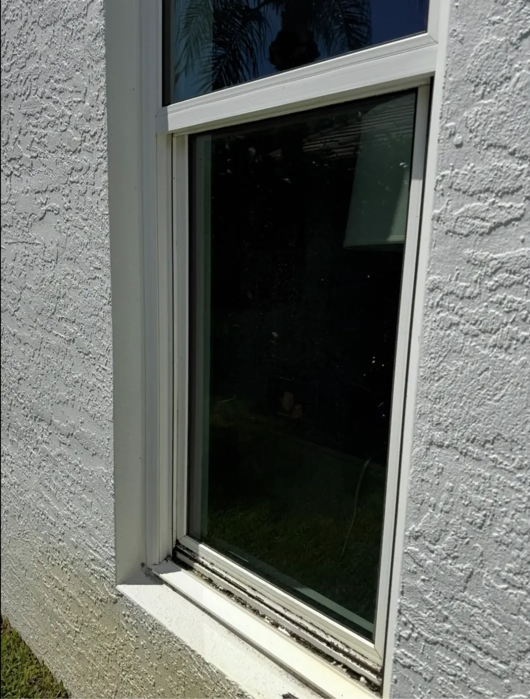 Filmed glass with a grimy bottom rail before cleaning