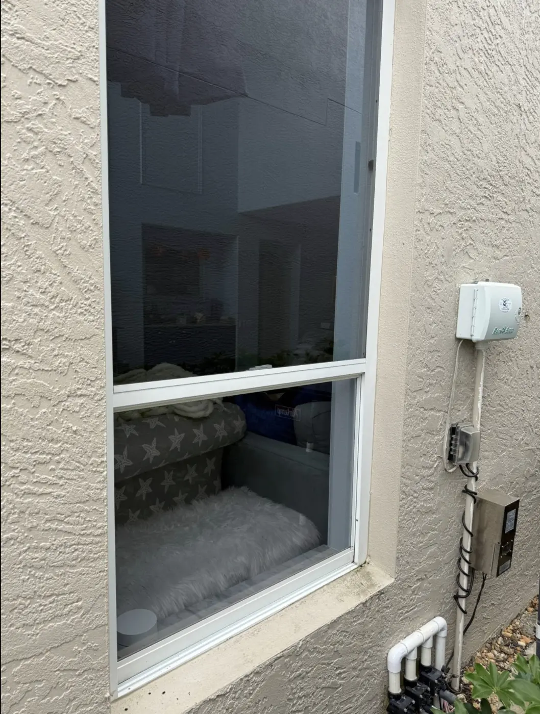 The same window, clear glass and clean rail after professional cleaning