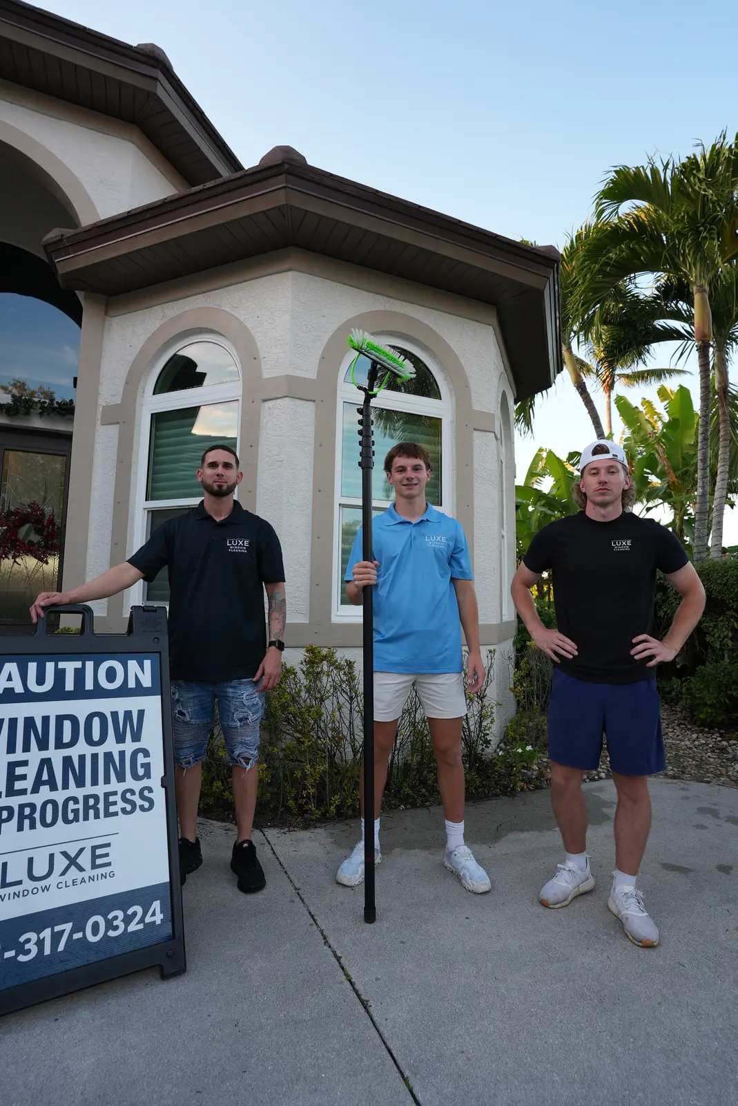 Three For His Glory team members with equipment in front of a Naples-area home