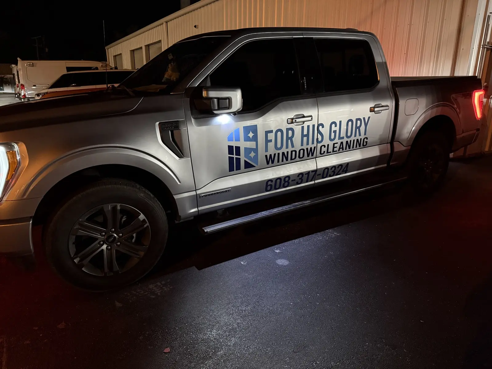 For His Glory branded truck with the company logo and phone number on the door